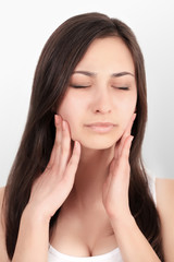 Fototapeta premium Teeth Problem. Woman Feeling Tooth Pain. Closeup Of Beautiful Sad Girl Suffering From Strong Tooth Pain. Attractive Female Feeling Painful Toothache. Dental Health And Care Concept. High Resolution