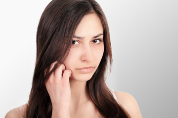 Fototapeta premium Woman In Pain. Closeup Of Beautiful Young Female Feeling Painful Toothache, Touching Face With Hand. Sad Stressed Girl Feeling Strong Teeth, Jaw Or Neck Pain. Dental Health And Care. High Resolution