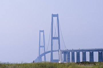 Cars driving up the ramp to the first giant tower of the Great Belt Bridge in Denmark