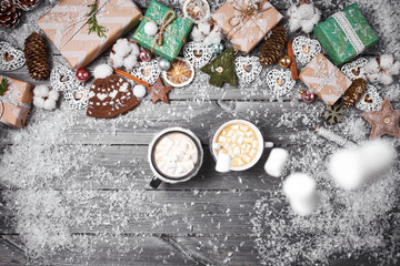 Fototapeta na wymiar Christmas decorations on an old wooden table. Hot chocolate, cocoa with marshmallows and popcorn on wooden background.