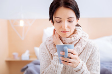 Sad woman having a terrible sore throat