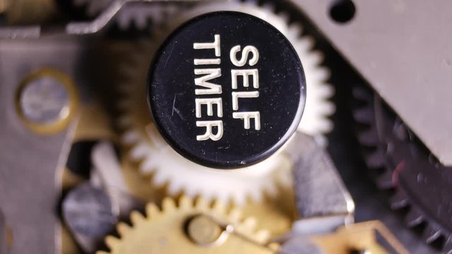 Cogwheel system of the self timer of a vintage camera - macro shot in 4K