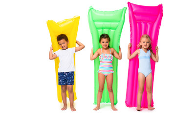 multiethnic kids with swimming mattresses