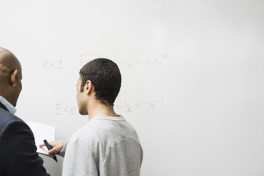 Teacher and student talking in classroom