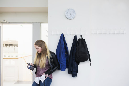 Female student using smartphone in school