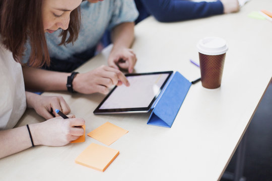 Students by desk in classroom
