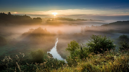 Obraz na płótnie Canvas Wonderful dawn at foggy valley in autumn