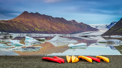 Kayaks at glacial lake in the cold mountains, Iceland © shaiith