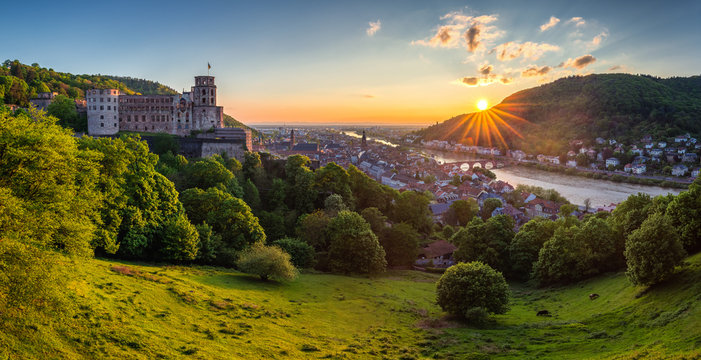 View on Heidelberg in autumn with red foliage including Carl Theodor Old Bridge, Neckar river, Church of the Holy Spirit, Germany