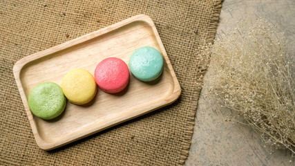 Colorful macaroons on gray background.