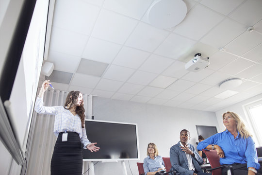 Female architect giving presentation during business meeting