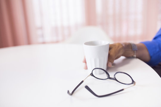 Human hand holding coffee cup