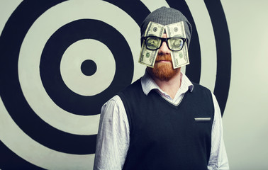 Concept - portrait of a Money Man. A man with glasses. One hundred US Dollars in the eyes. Watch...