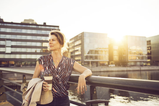 Businesswoman with disposable cup