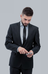 Handsome businessman in suit using the phone in office