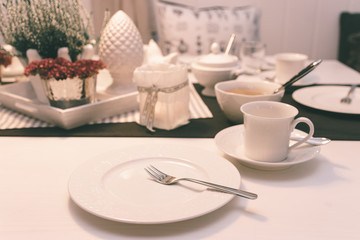 Breakfast table with white dishes