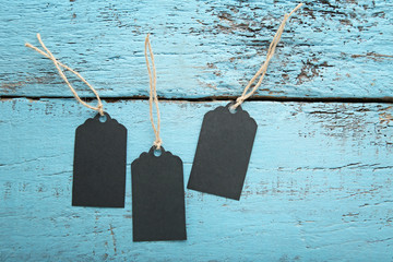 Black sale tags on blue wooden table