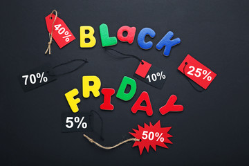 Inscription Black Friday by colourful letters with sale tags