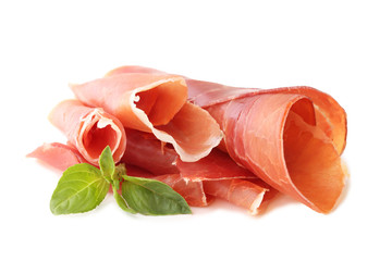 Slices of jamon with basil leafs isolated on white background