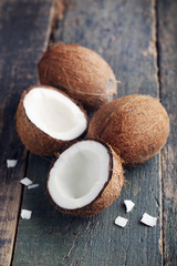 Coconuts on sackcloth napkin on brown wooden table
