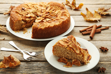 Apple cake in plate on grey wooden table