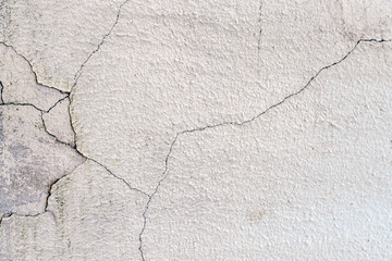 Grunge concrete cement wall with crack in industrial building