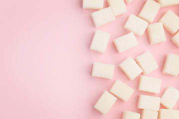 Sugar cubes on pink background