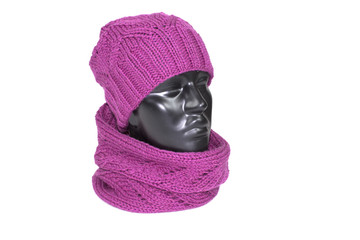 Scarf and hat knitted dressed on the head of a mannequin, isolated on white background