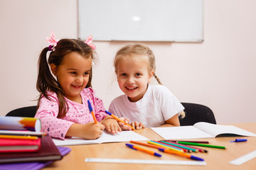 Fototapeta premium education and school concept - little student girl studying and reading book at school