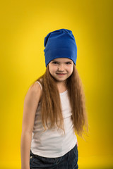 Beautiful caucasian girl posing in studio on a Yellow isolated background