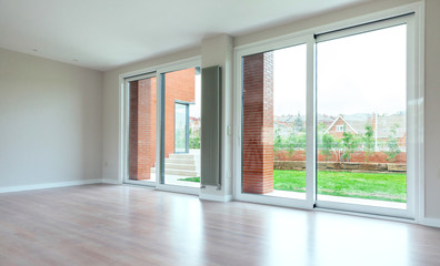 Large living room with large windows overlooking the garden