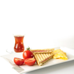 Scrambled eggs and toasts. Selective focus with turkish tea