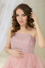 Fototapeta premium Portrait of pregnant woman in pink