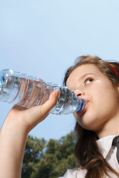 Young girl drinking from bottle