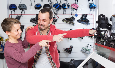 Father buying roller-skates for his son