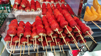 Fresh Strawberry  with wooden skewer  at street food in Ameya Yokocho market,Ueno ,Japan.