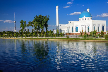 The White Mosque Minor with turquoise dome, one of new sights of Tashkent, located in the new part of the city on the embankment of the Ankhor channel and is surrounded by a landscaped area
