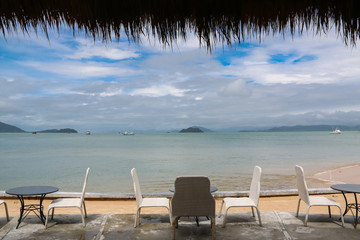 Beautiful view of sea with white chairs  and blue sky in the Andaman sea ,Ranong ,THAILAND.
