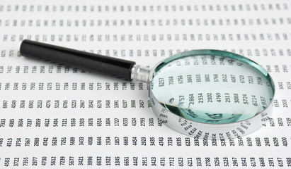magnifying glass and document with figures