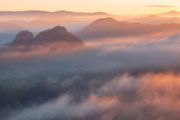 sunrise from foggy Kleiner Winterberg in the national park Saxon Switzerland, Germany