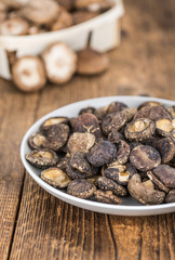 Wooden table with Dried Shiitake, selective focus