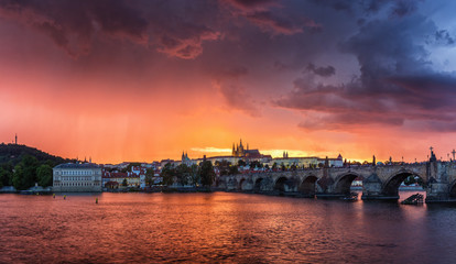 Fantastic natural phenomena summer storm over Charles bridge, Prague castle and Vltava river in Prague, Czech Republic