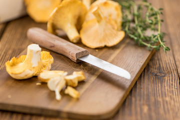 Portion of fresh harvested Chanterelles on wooden background