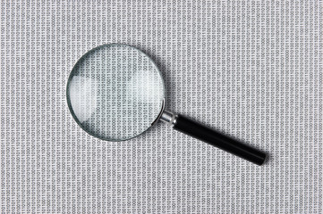 magnifying glass on a binary code