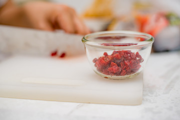 Cutting strawberry in kitchen
