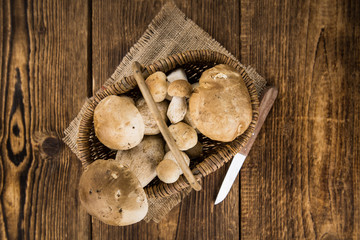 Fresh Porcinis (raw) on a vintage background (close-up shot)