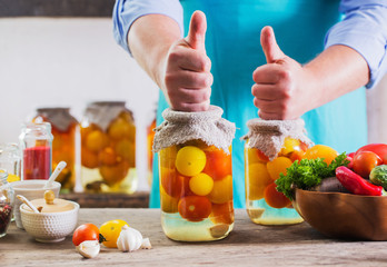 men with vegetables in jars