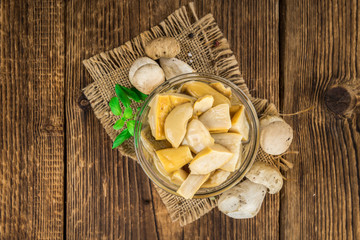 Preserved Porcinis on vintage wooden background