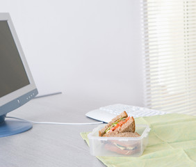sandwich in lunchbox on desk