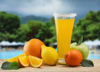 Glass of orange juice on a beach